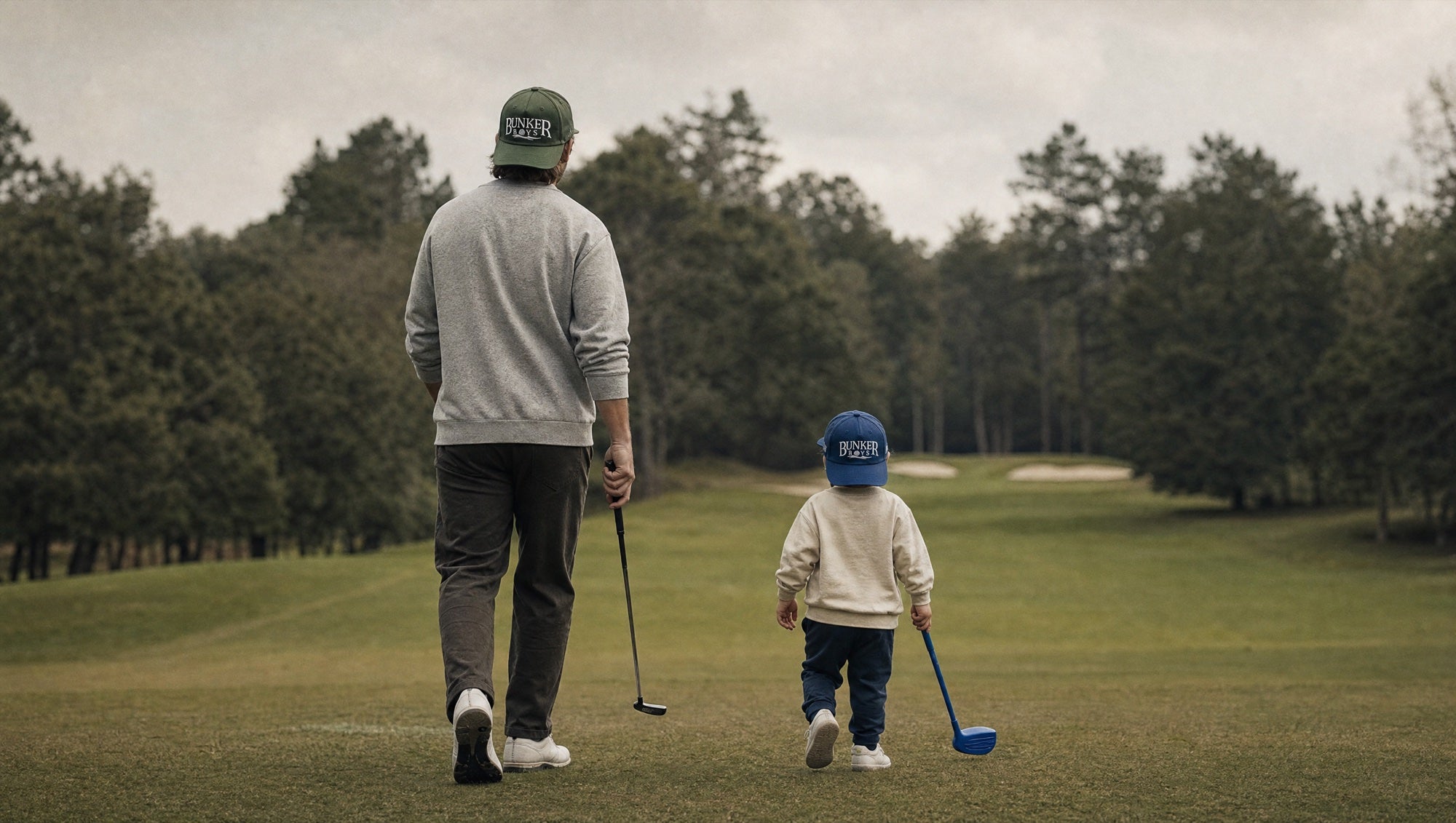 Father and toddler in matching Bunker Boys hats on the course